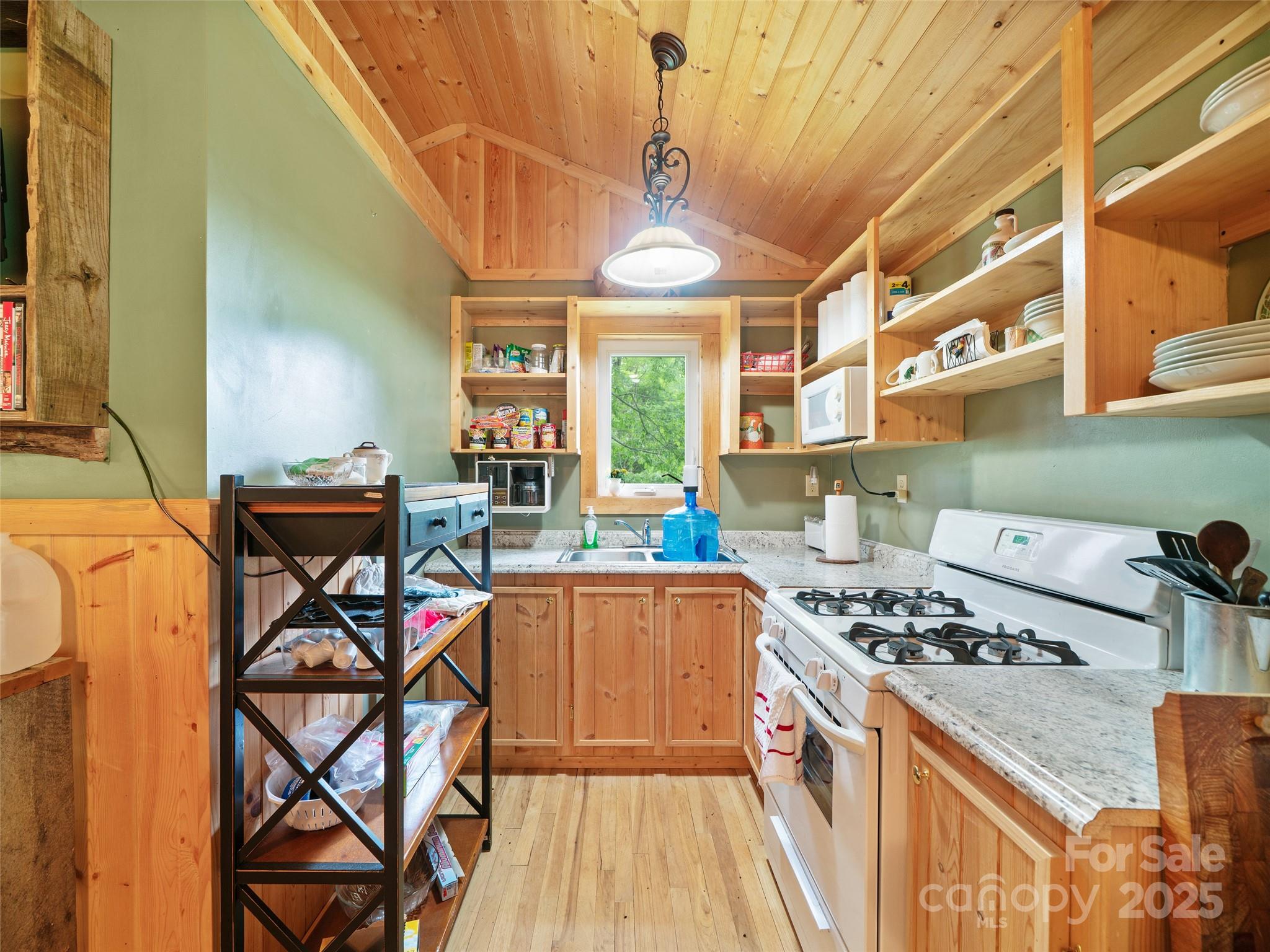 289 Bailey Settlement Road Green Mountain, NC 28740 - Photo 5 of 21 a kitchen that has a lot of cabinets in it and a wooden floor