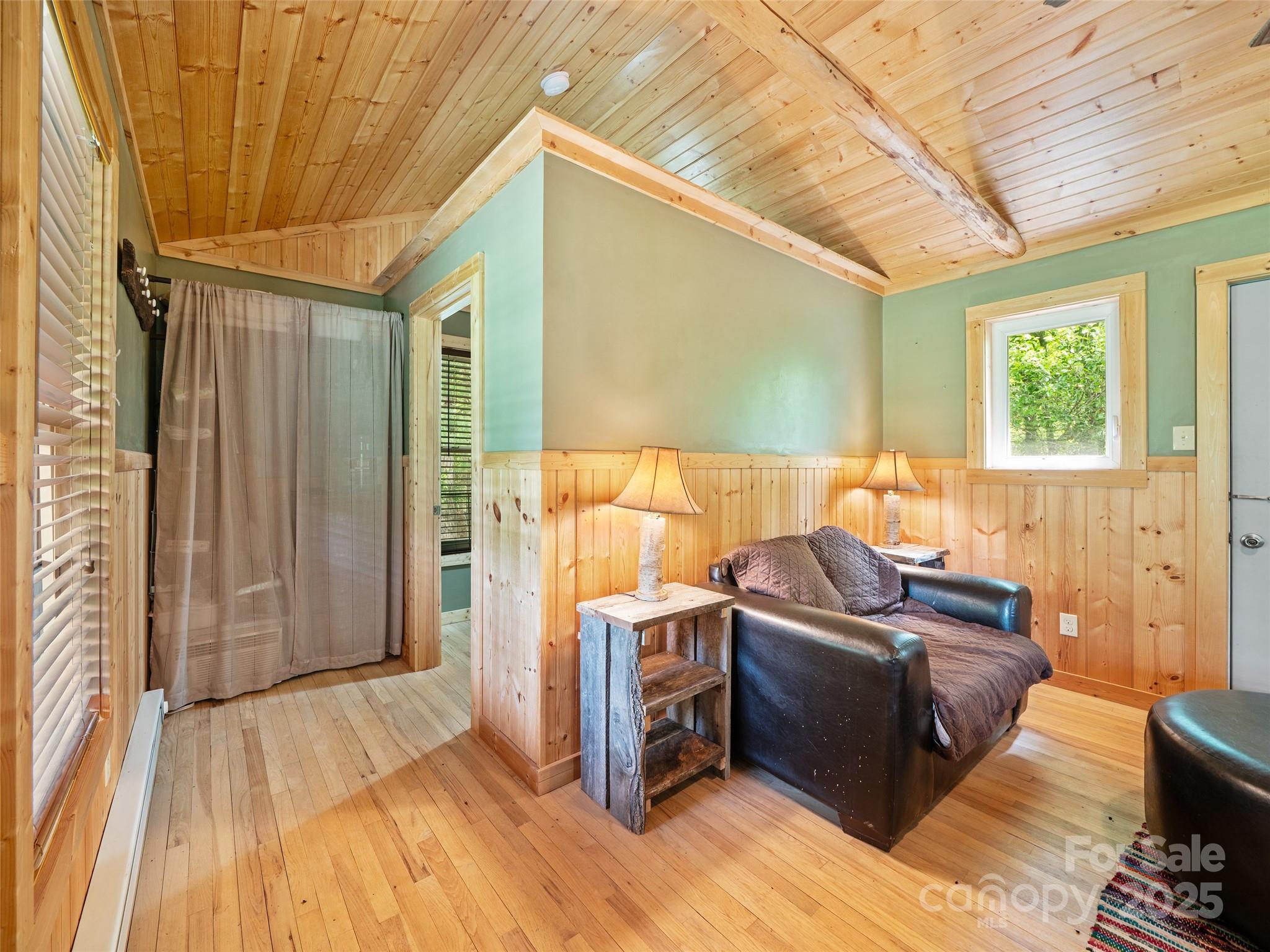 289 Bailey Settlement Road Green Mountain, NC 28740 - Photo 6 of 21 a view of a livingroom with furniture and wooden floor