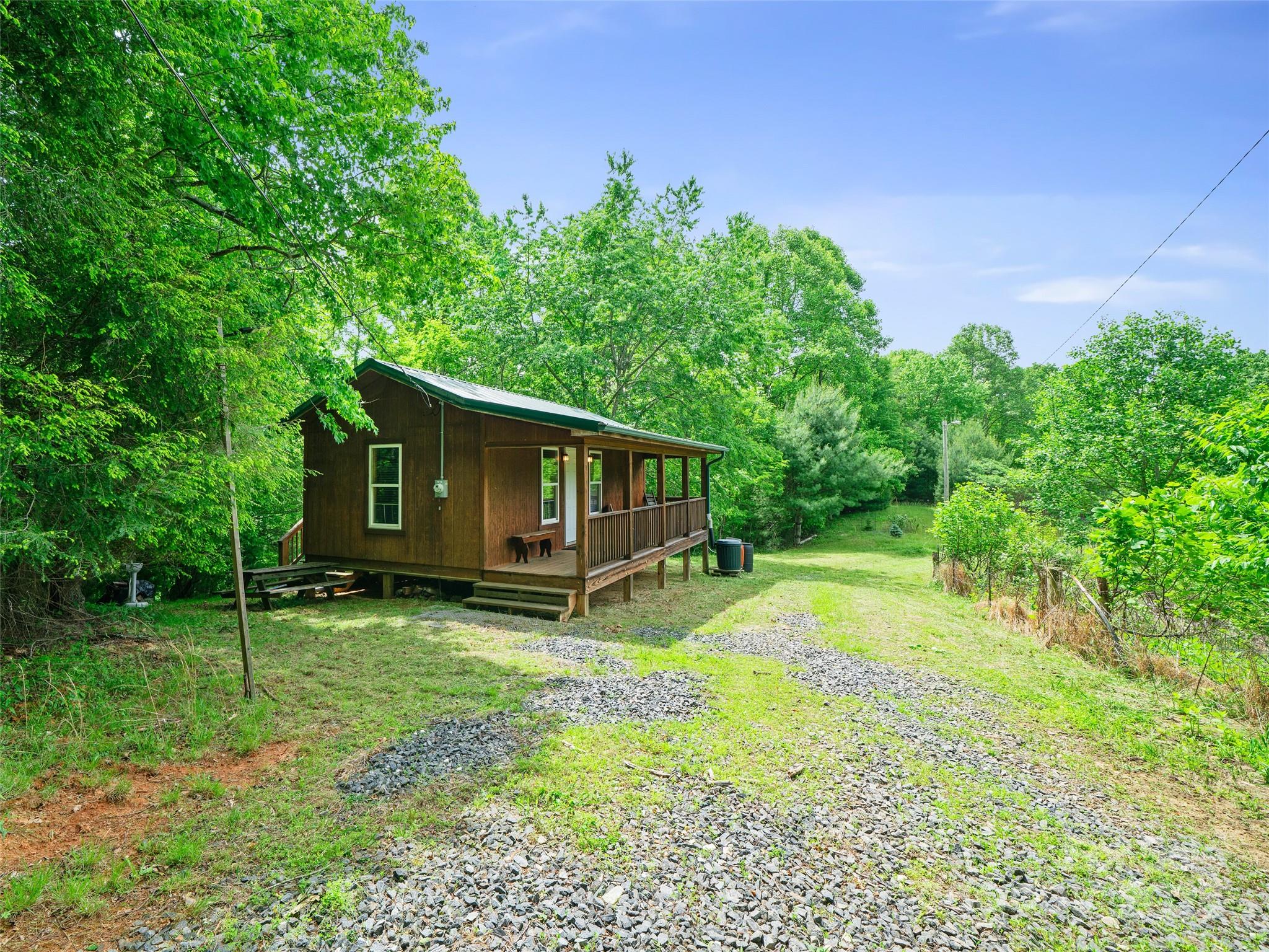 289 Bailey Settlement Road Green Mountain, NC 28740 - Photo 10 of 21 a backyard of a house with barbeque oven table and chairs