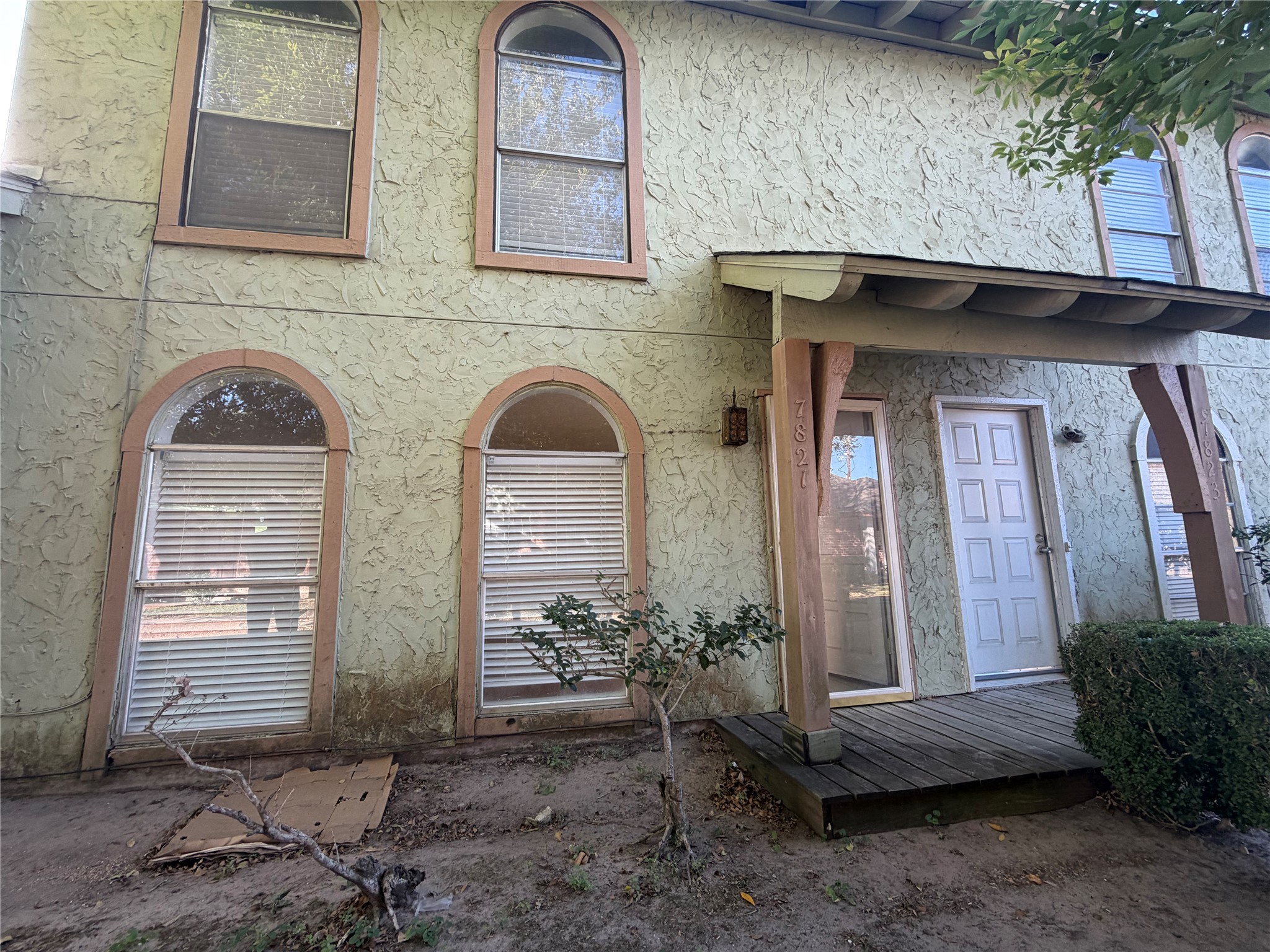 7821 Cook Road Houston, TX 77072 - Photo 1 of 14 a front view of a house with garden