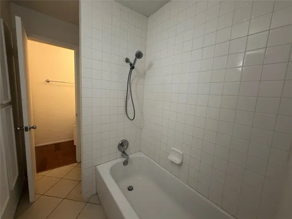 a bathroom with a tub and a shower
