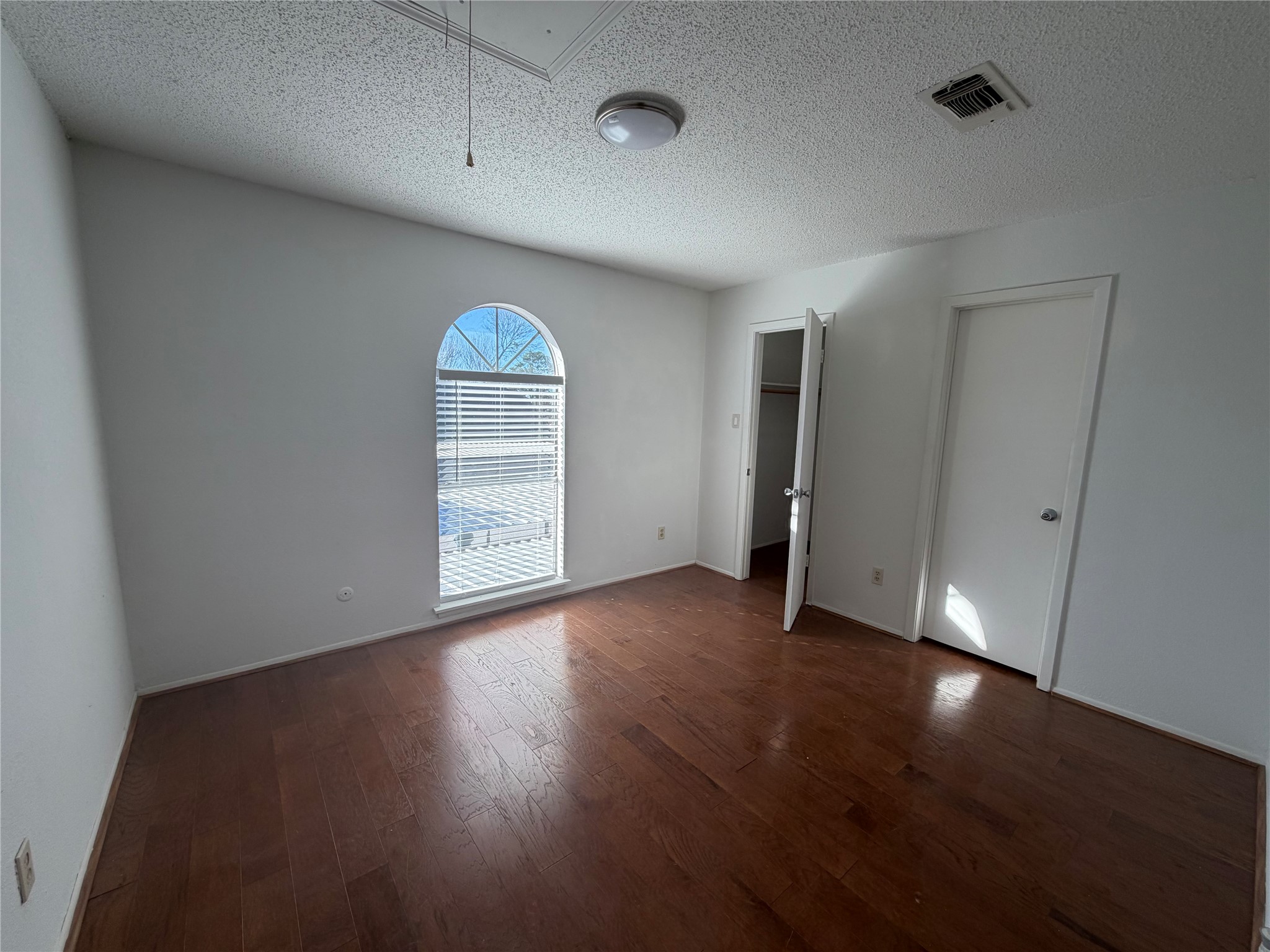 7821 Cook Road Houston, TX 77072 - Photo 8 of 14 wooden floor in an empty room with a window