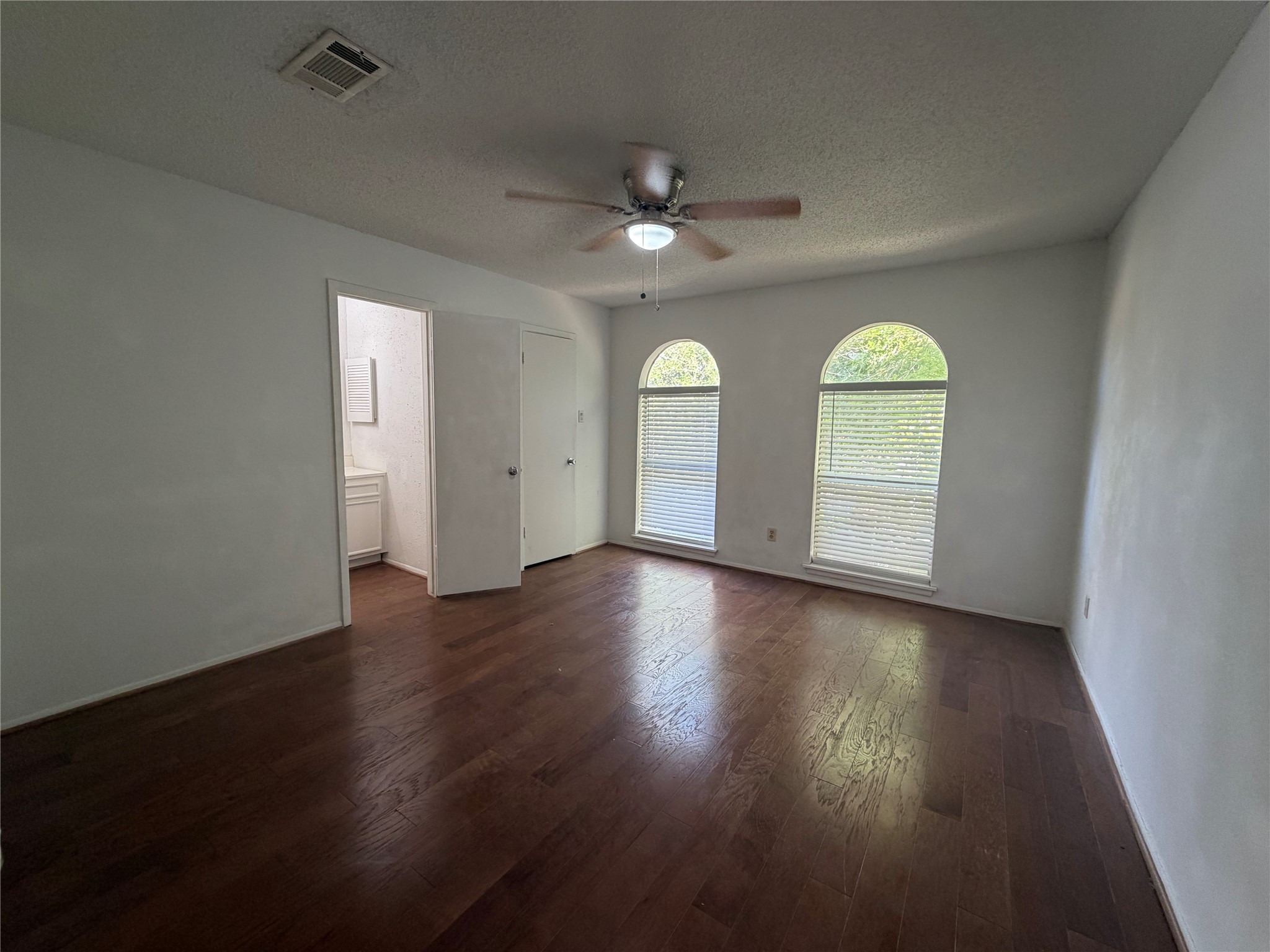 7821 Cook Road Houston, TX 77072 - Photo 9 of 14 an empty room with wooden floor and windows