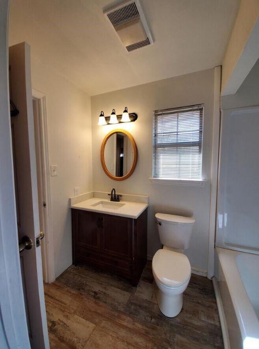10948 Fm 898 Whitewright, TX 75491 - Photo 36 of 39 a bathroom with a toilet sink and mirror