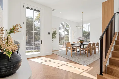 a view of a dining room with furniture and a potted plant
