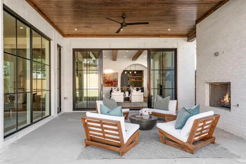 a living room with patio furniture and a fireplace