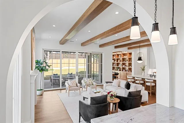 a living room with furniture and large windows