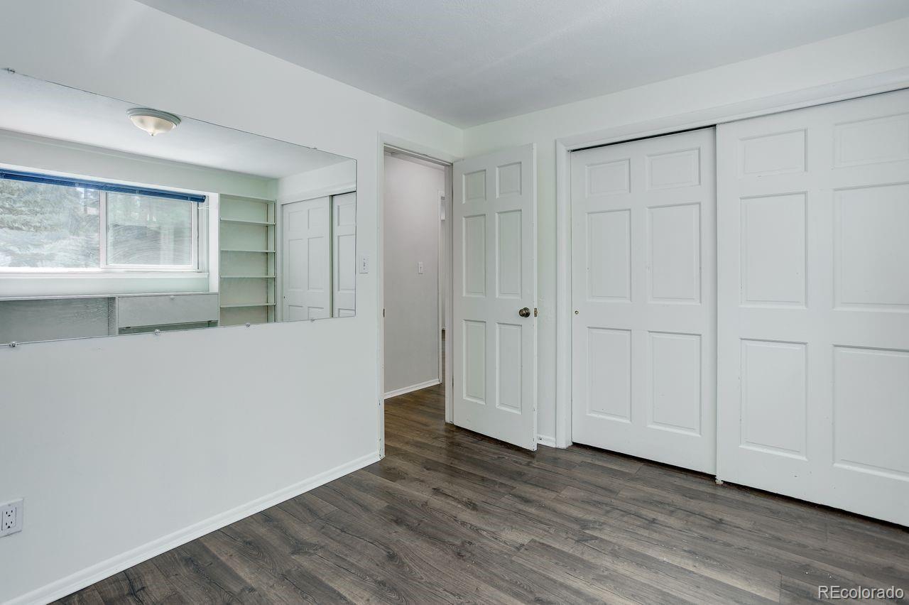 8795 Rudd Road Evergreen, CO 80439 - Photo 18 of 37 a view of a room with wooden floor and cabinet