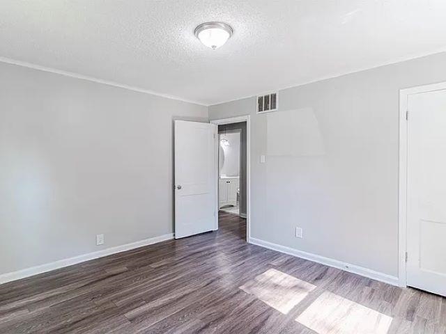 3530 Wilshire Road Memphis, TN 38111 - Photo 6 of 12 a view of an empty room with wooden floor and a window