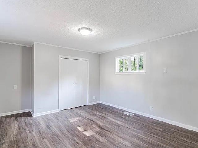 3530 Wilshire Road Memphis, TN 38111 - Photo 8 of 12 a view of an empty room with wooden floor and a window