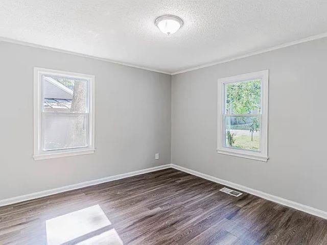 3530 Wilshire Road Memphis, TN 38111 - Photo 9 of 12 a view of an empty room with wooden floor and a window