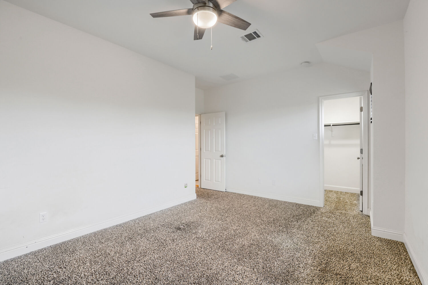 5821 Buchanan Draw Road Austin, TX 78738 - Photo 23 of 29 A spacious, naturally illuminated room featuring a ceiling fan and plush carpeting.