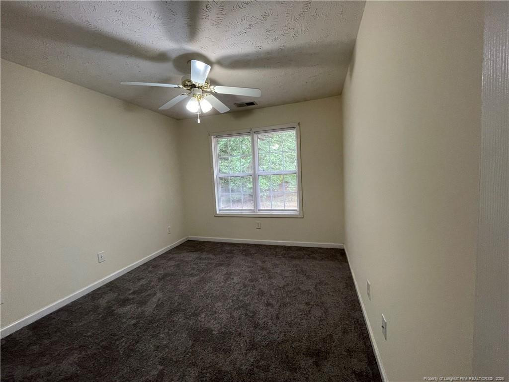522 Longview Drive, Unit B Fayetteville, NC 28311 - Photo 6 of 10 an empty room with a window and a fan