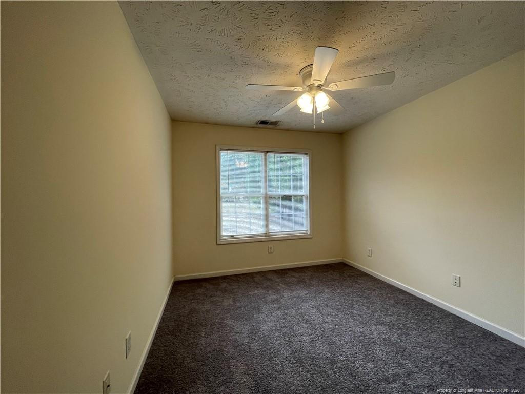 522 Longview Drive, Unit B Fayetteville, NC 28311 - Photo 9 of 10 an empty room with a window and a fan