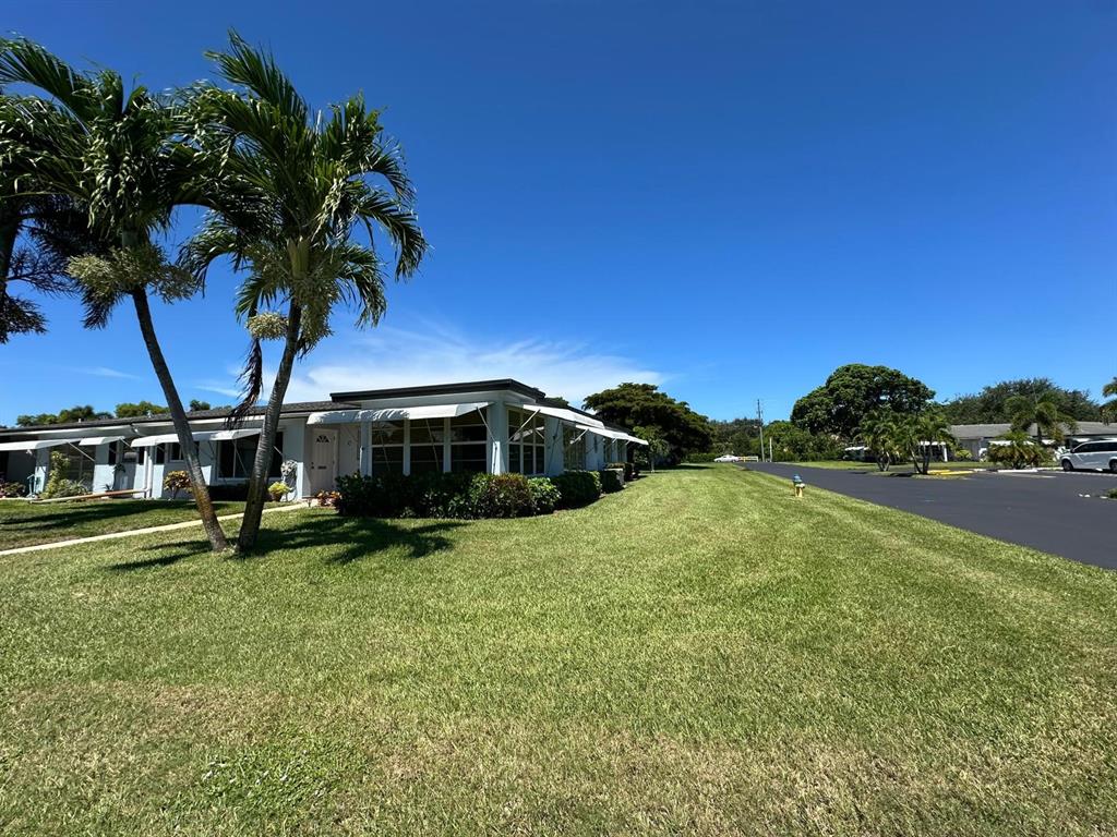a yellow house with trees in front of it