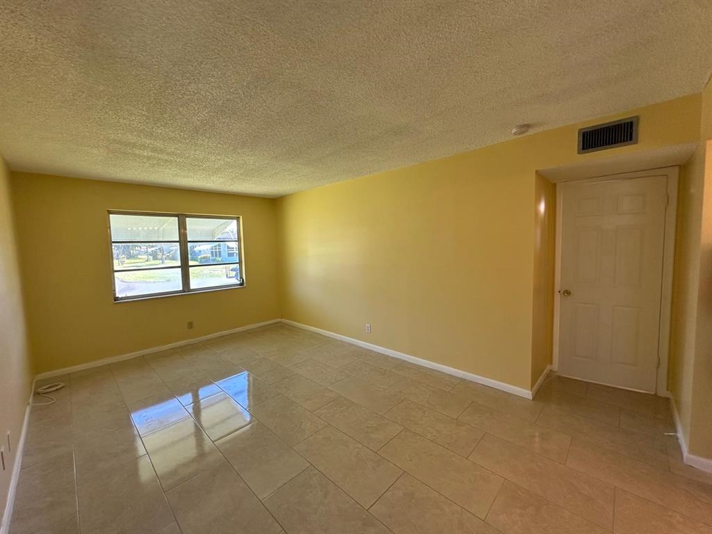 665 High Point Drive Delray Beach, FL 33445 - Photo 14 of 22 an empty room with windows