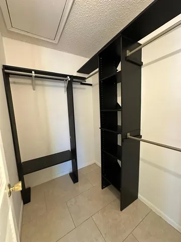 a view of closet with wooden floor