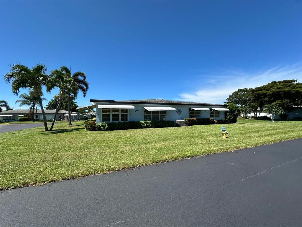 665 High Point Drive Delray Beach, FL 33445 - Photo 22 of 22 a front view of a house with a yard