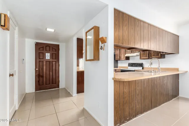 a kitchen with stainless steel appliances granite countertop a refrigerator and a sink