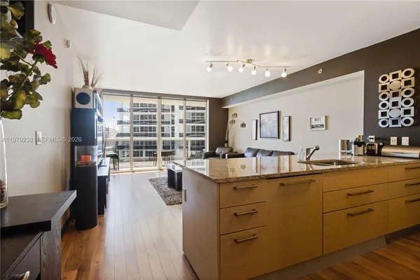a kitchen with sink stove and cabinets