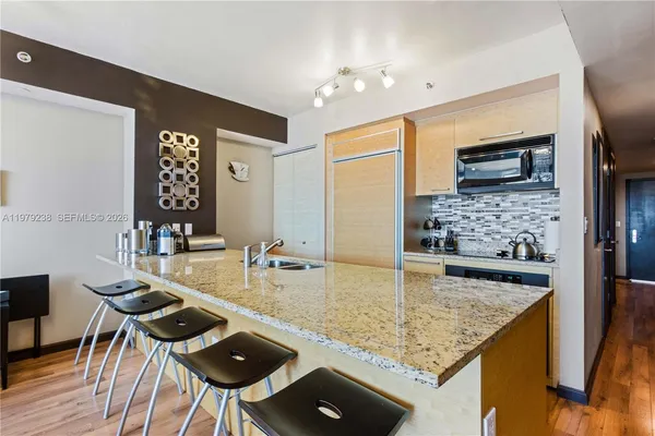 a kitchen with sink and refrigerator