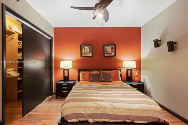 a bedroom with a bed and wooden floor