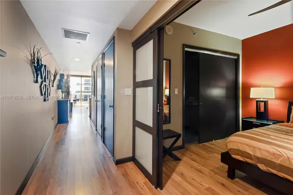 a bedroom with a bed and a wooden floor