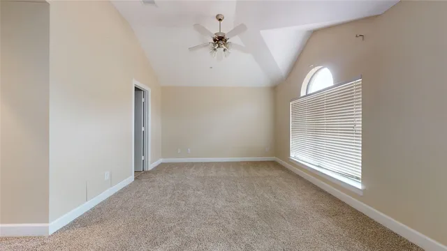 a view of an empty room with closet and wooden floor