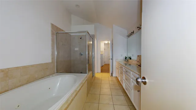 a bathroom with a bath tub and shower