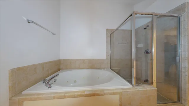 a bathroom with a shower and a bathtub