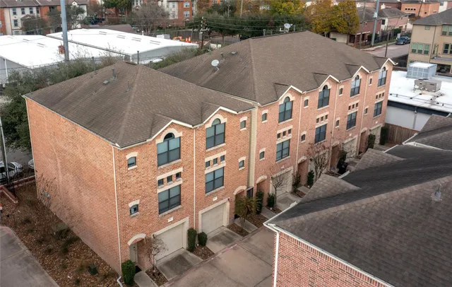 an aerial view of residential houses with outdoor space