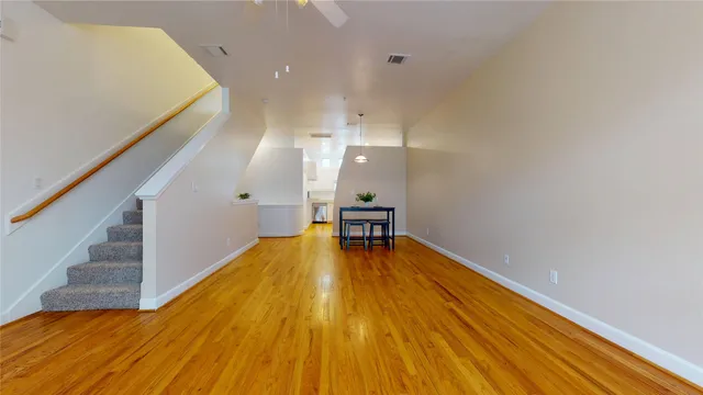 a kitchen with stainless steel appliances granite countertop a stove top oven a sink dishwasher and a microwave oven on the blue kitchen countertops with wooden floor