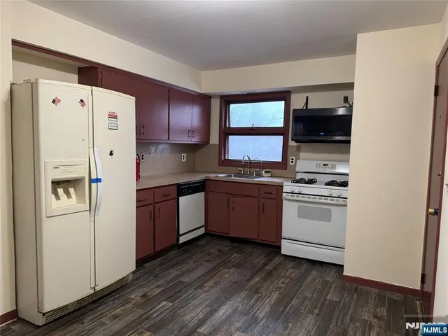 a kitchen with a white cabinets and white appliances