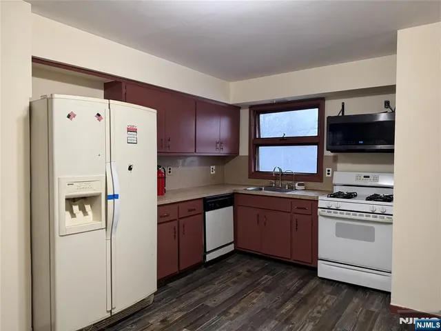 a kitchen with stainless steel appliances a refrigerator stove and sink