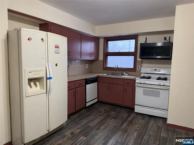 a kitchen with stainless steel appliances a refrigerator stove and microwave