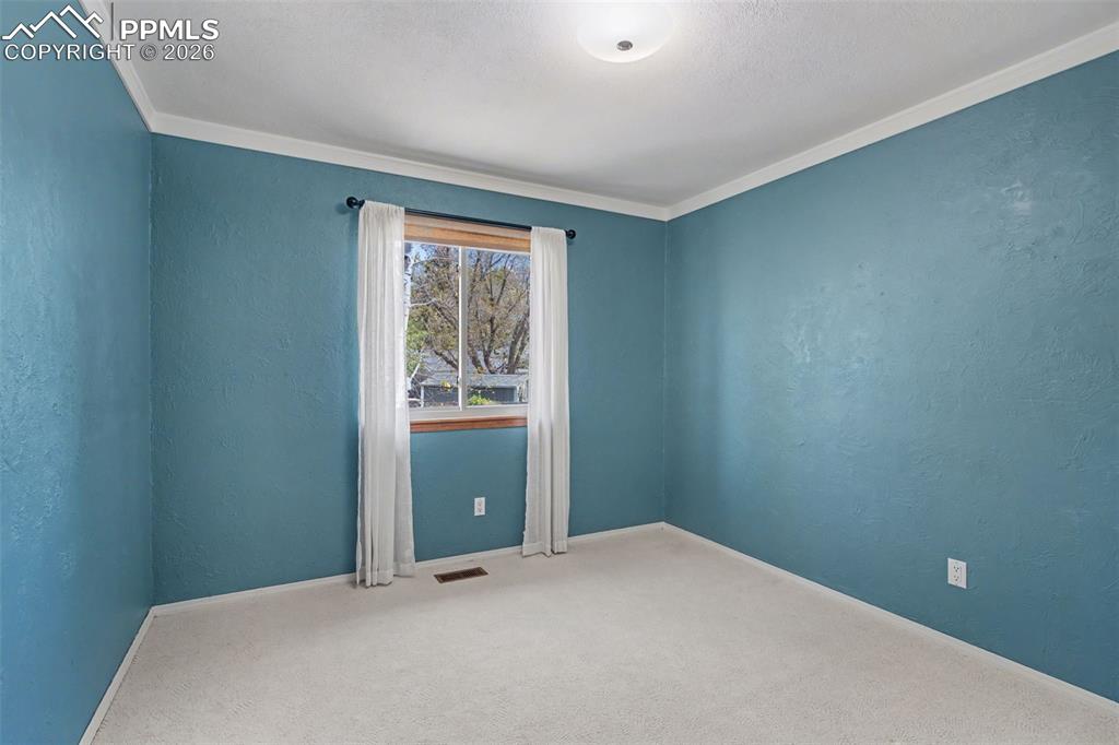 5301 Pinon Valley Road Colorado Springs, CO 80919 - Photo 15 of 27 a bedroom with a bed and a window
