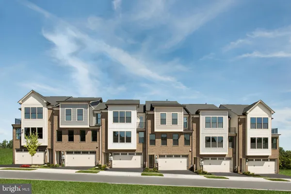 a front view of a residential apartment building with a yard