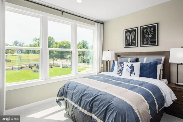 a bed sitting in a bedroom next to a window