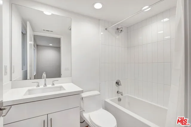 a front view of a house with a yard and potted plants