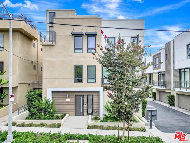 a front view of a building with a garden