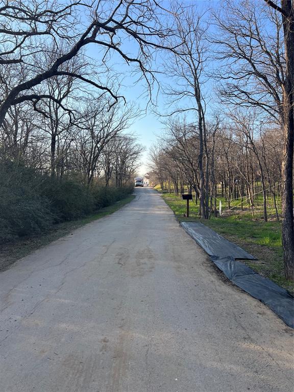 9220 Apache Trail Flower Mound, TX 75022 - Photo 5 of 21 Tree lined street in front of property