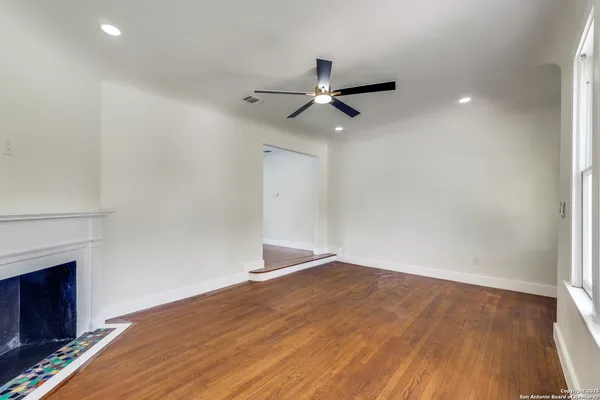 wooden floor in an empty room with a fireplace