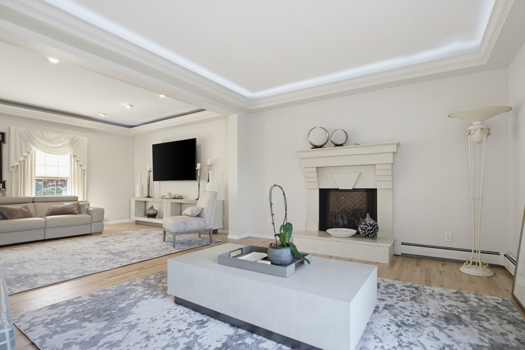 226 Olympic Road Somerset, MA 02726 - Photo 14 of 42 a living room with furniture a flat screen tv and a fireplace