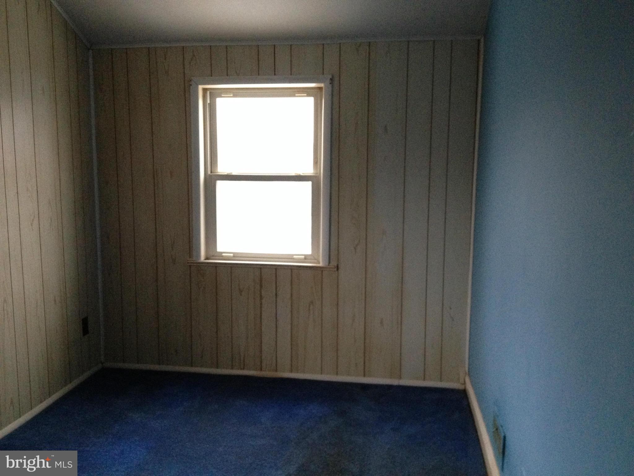 455 Torner Road Baltimore, MD 21221 - Photo 18 of 30 a view of an empty room with wooden floor and a window
