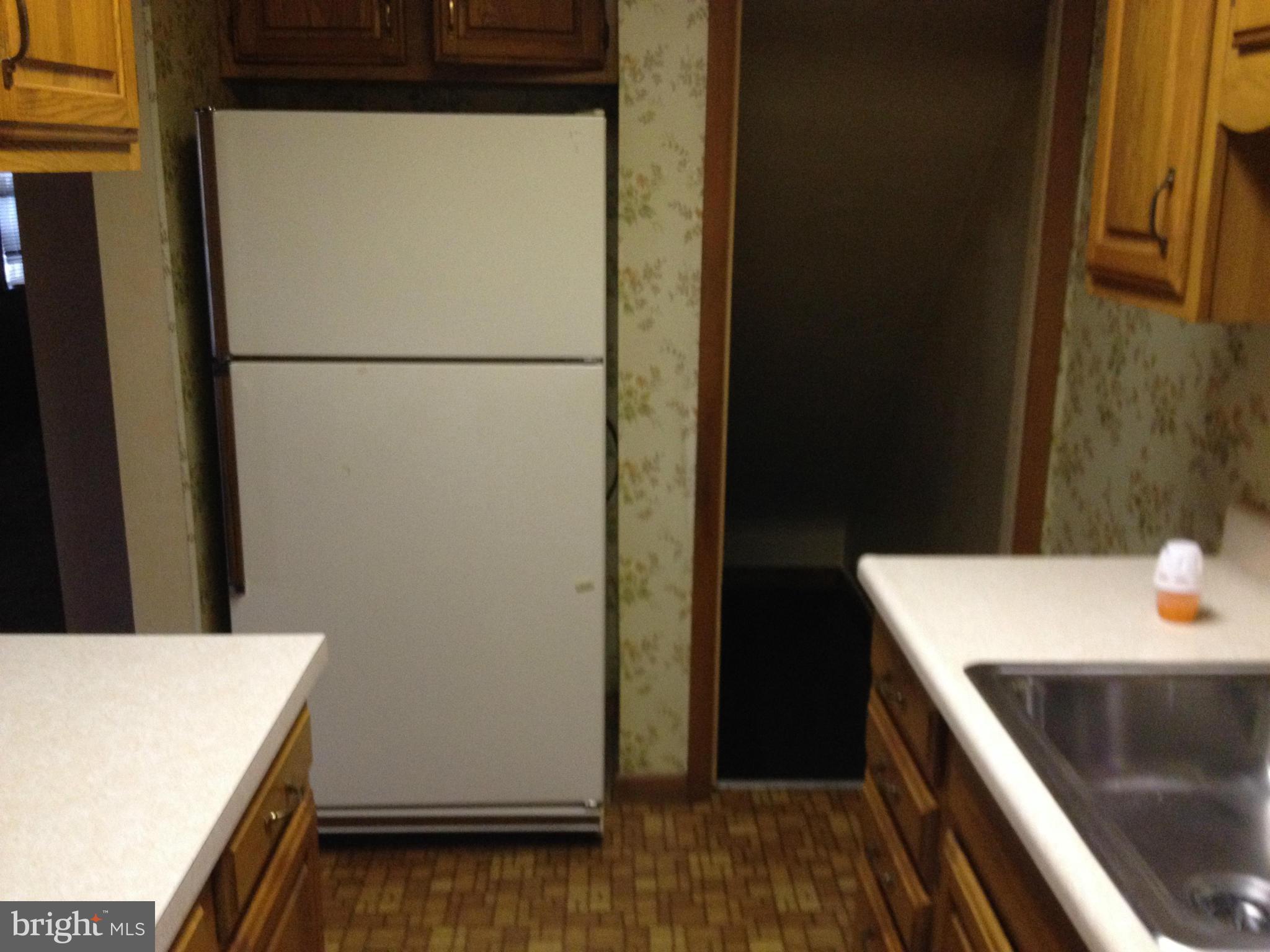 455 Torner Road Baltimore, MD 21221 - Photo 29 of 30 a kitchen with a refrigerator and a stove