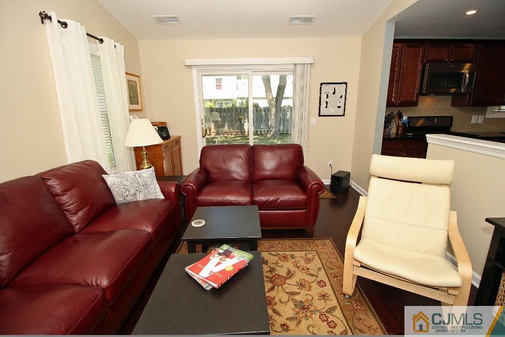 157 Woodbury Road Edison, NJ 08820 - Photo 14 of 25 a living room with furniture a flat screen tv and a window