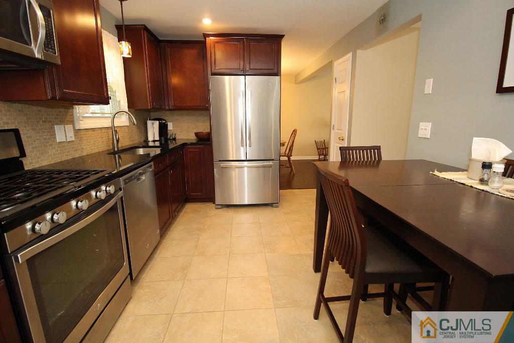 157 Woodbury Road Edison, NJ 08820 - Photo 8 of 25 a kitchen with a sink appliances and cabinets