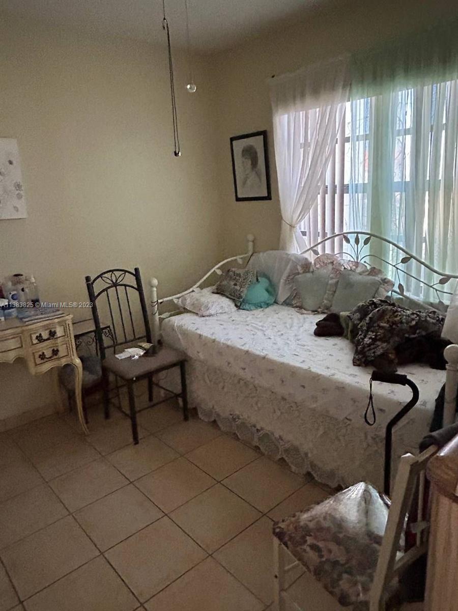 West End Miami, FL 33193 - Photo 3 of 5 a bedroom with a bed and a window