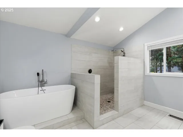 a bathroom with a bathtub and shower