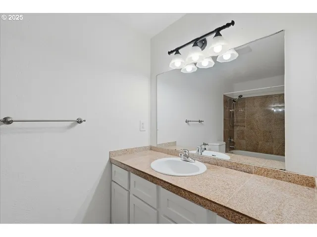 a bathroom with a sink vanity and a mirror